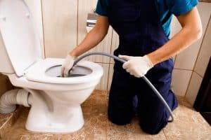 unclogging toilet.